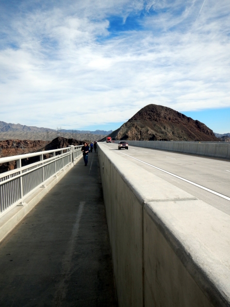 you walk along the edge of the highway bridge to look down onto Hoover Dam
